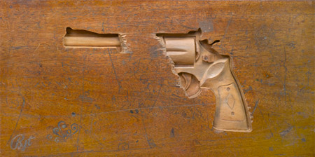 Revolver Carved into a Wooden Desk