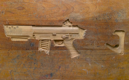 Gun Carved into a Wooden Desk