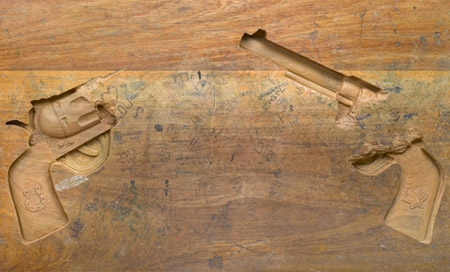Pistols Carved into a Wooden Desk